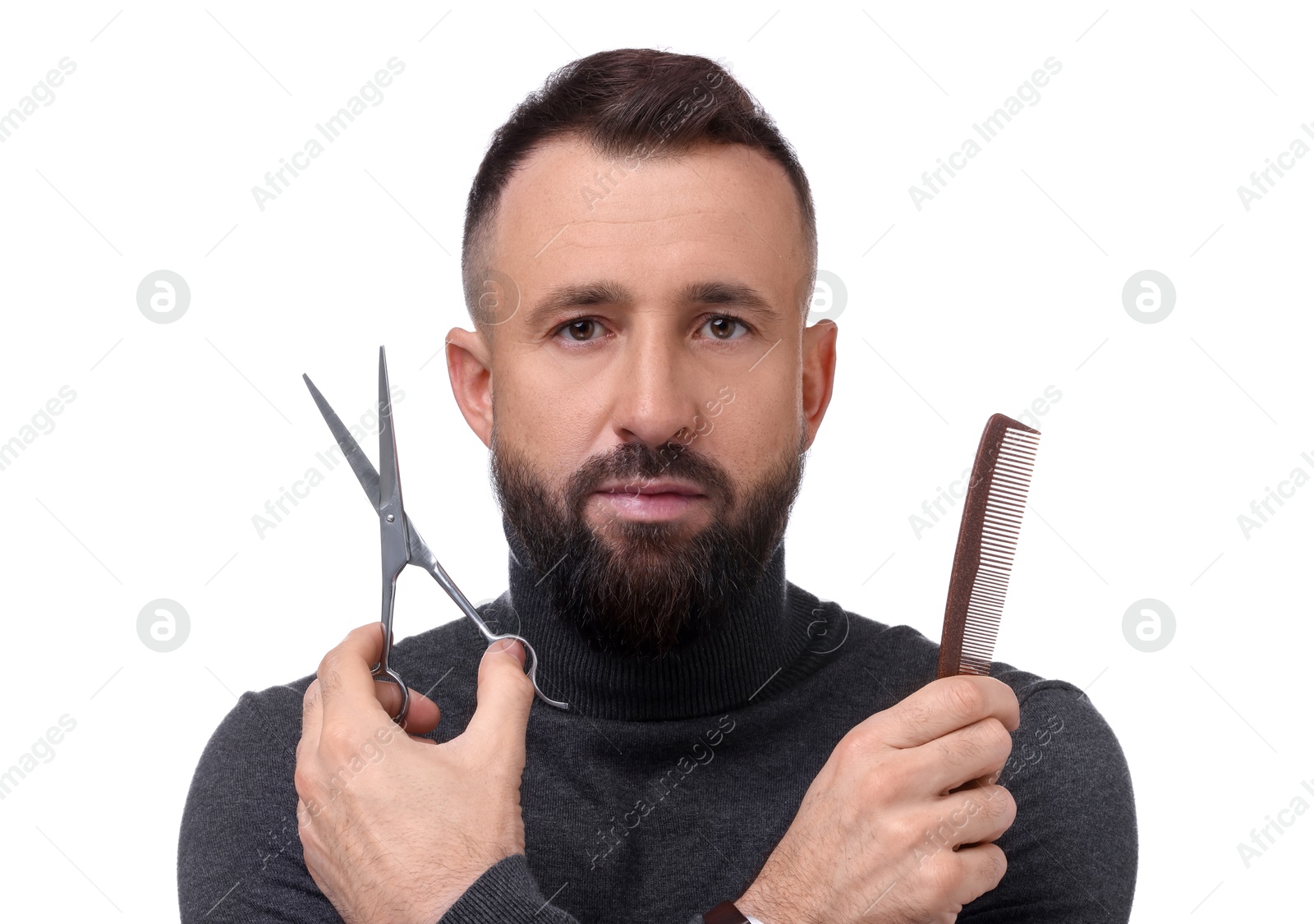 Photo of Bearded man holding comb and scissors on white background