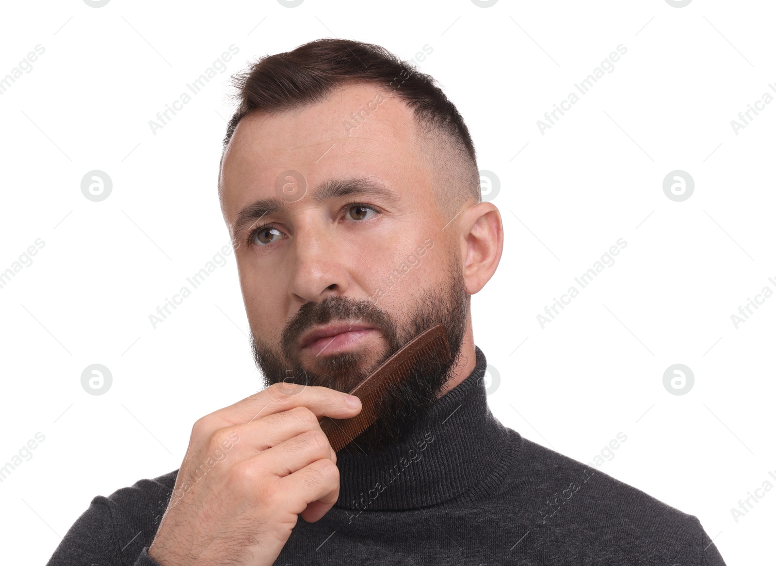 Photo of Handsome man combing beard on white background