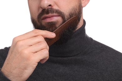 Photo of Man combing beard on white background, closeup