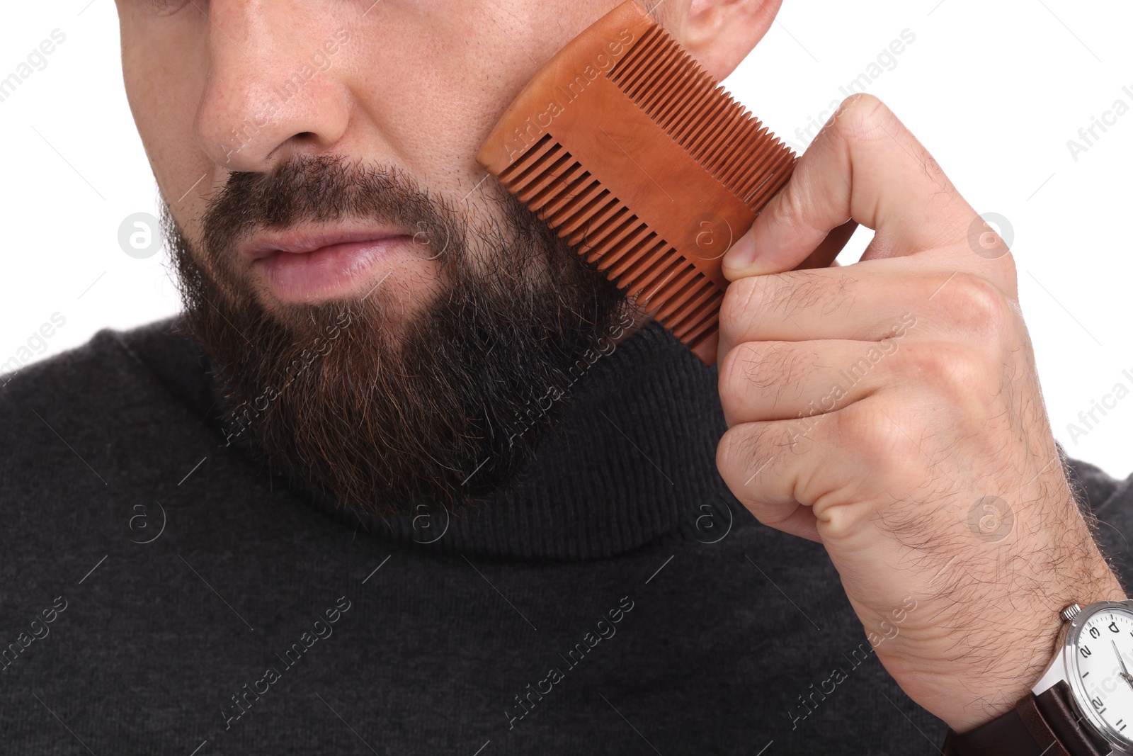 Photo of Man combing beard on white background, closeup