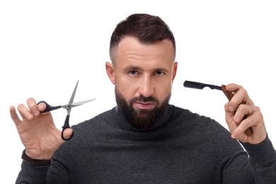 Photo of Bearded man holding blade and scissors on white background