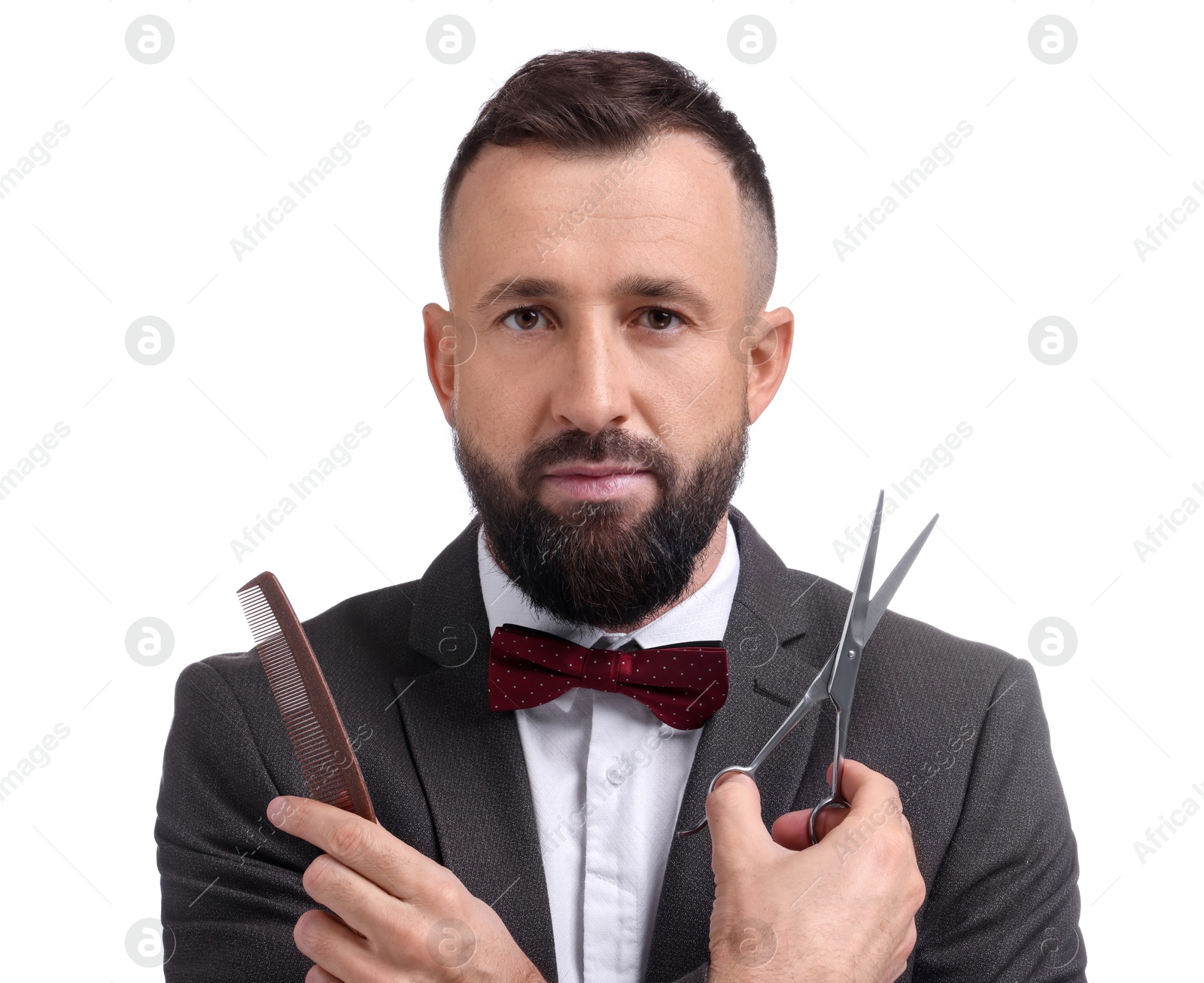 Photo of Bearded man holding comb and scissors on white background