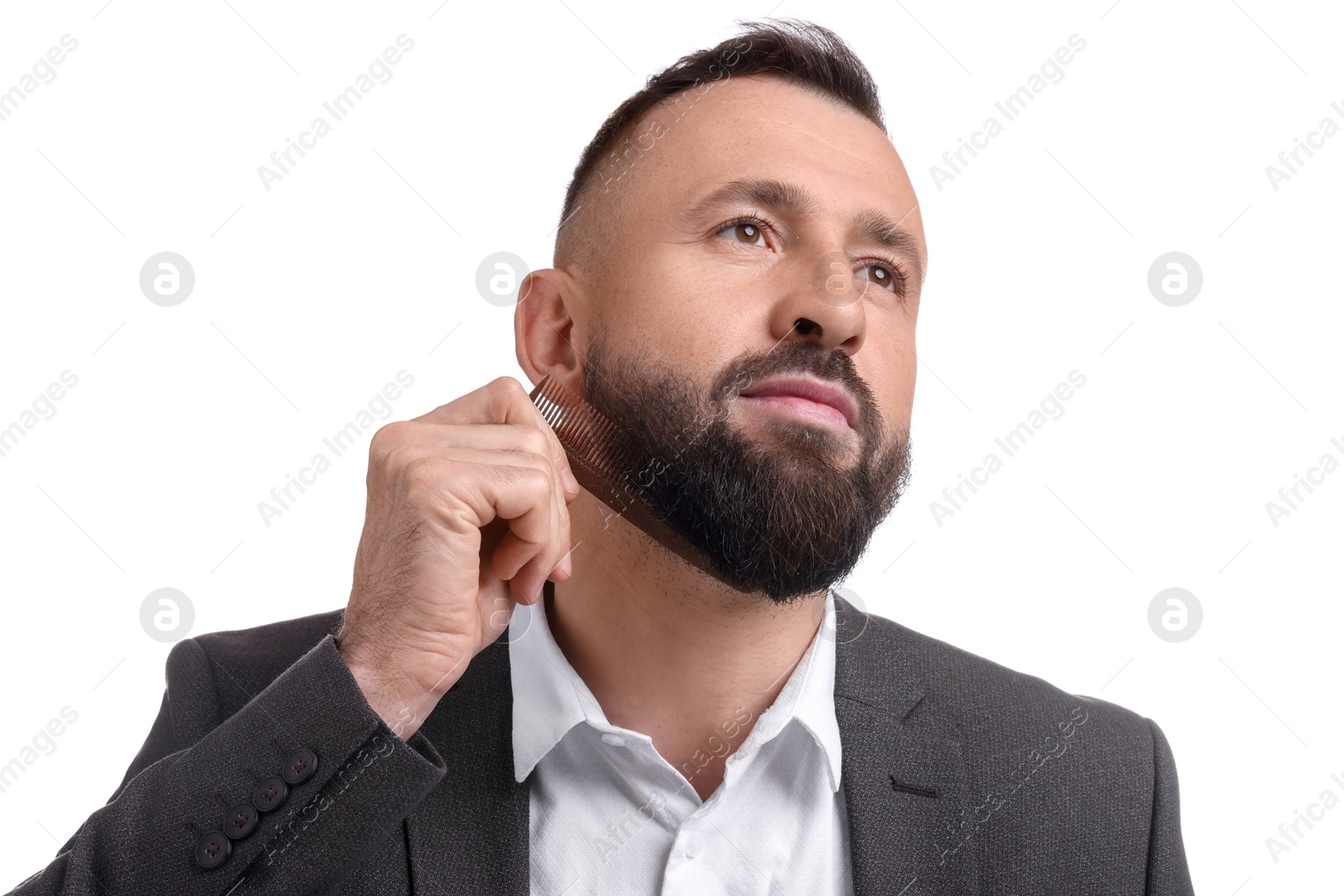 Photo of Handsome man combing beard on white background