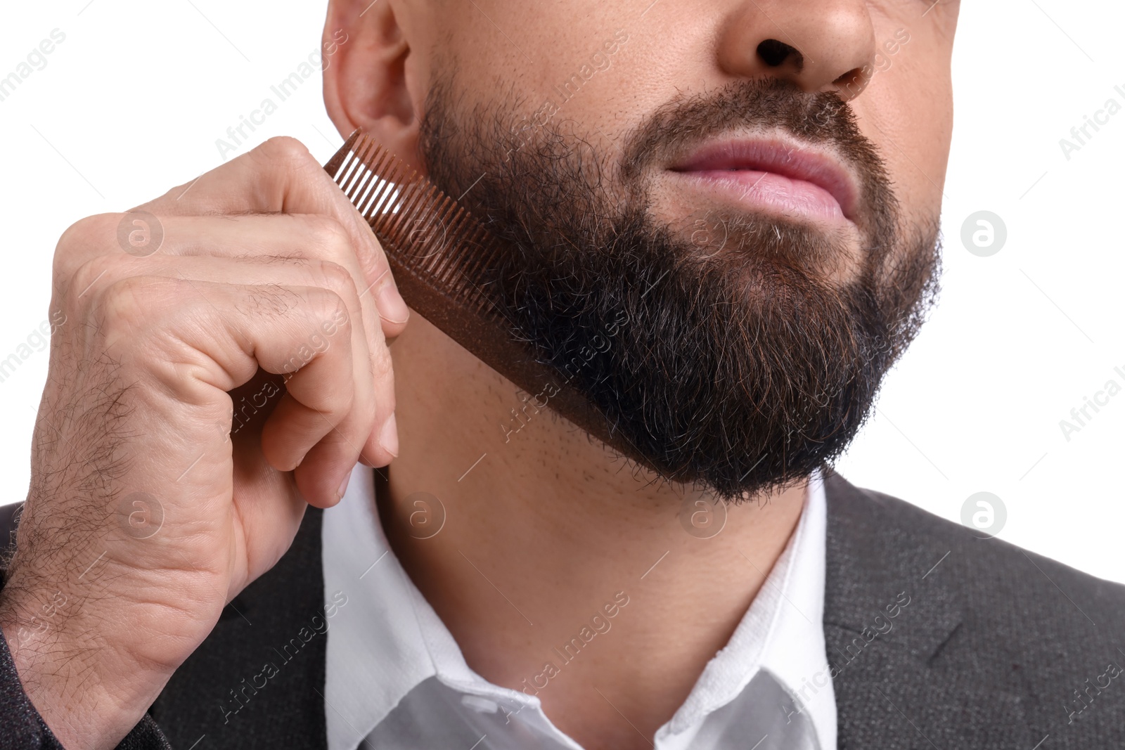 Photo of Man combing beard on white background, closeup