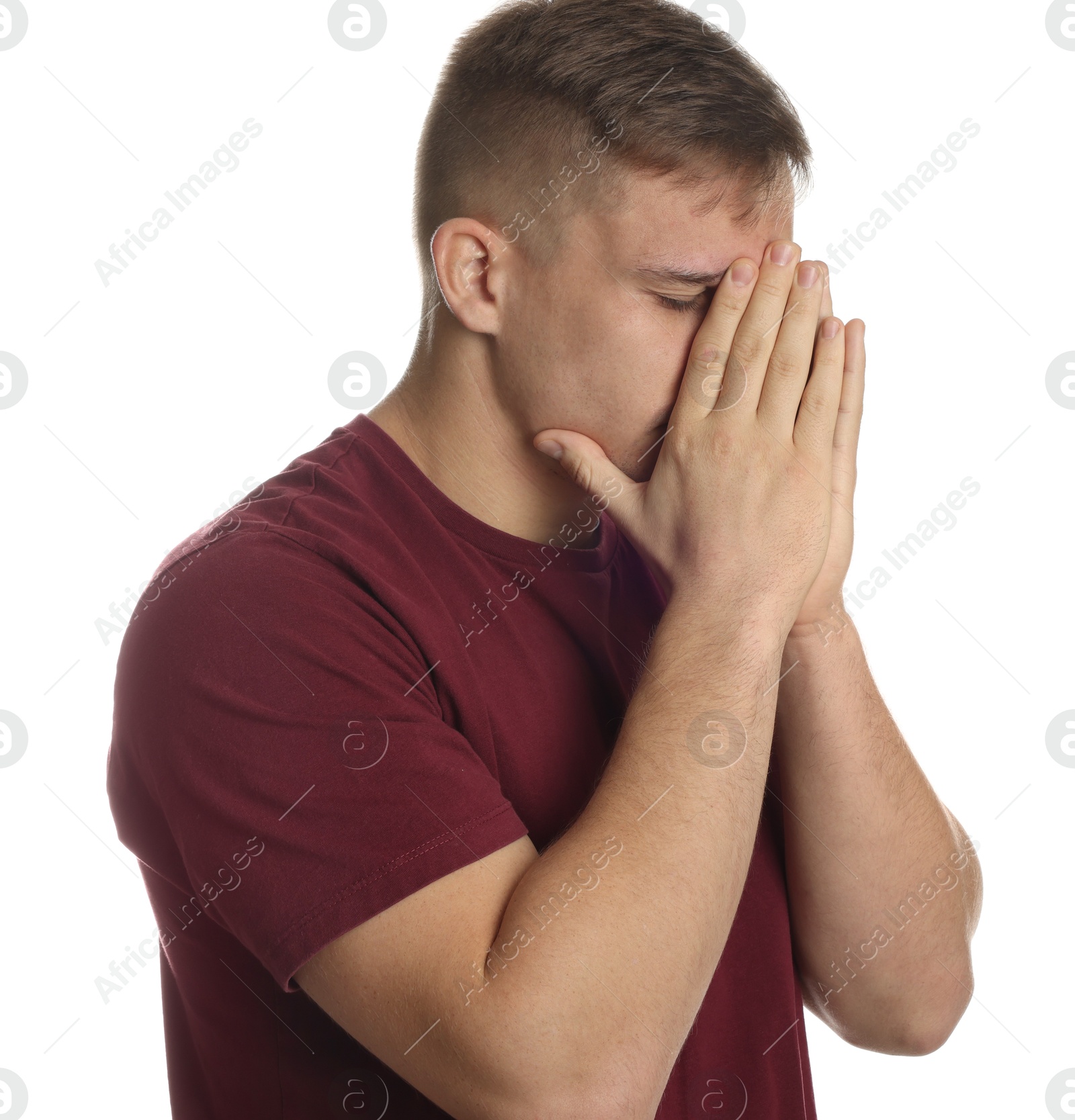 Photo of Distressed young man crying on white background