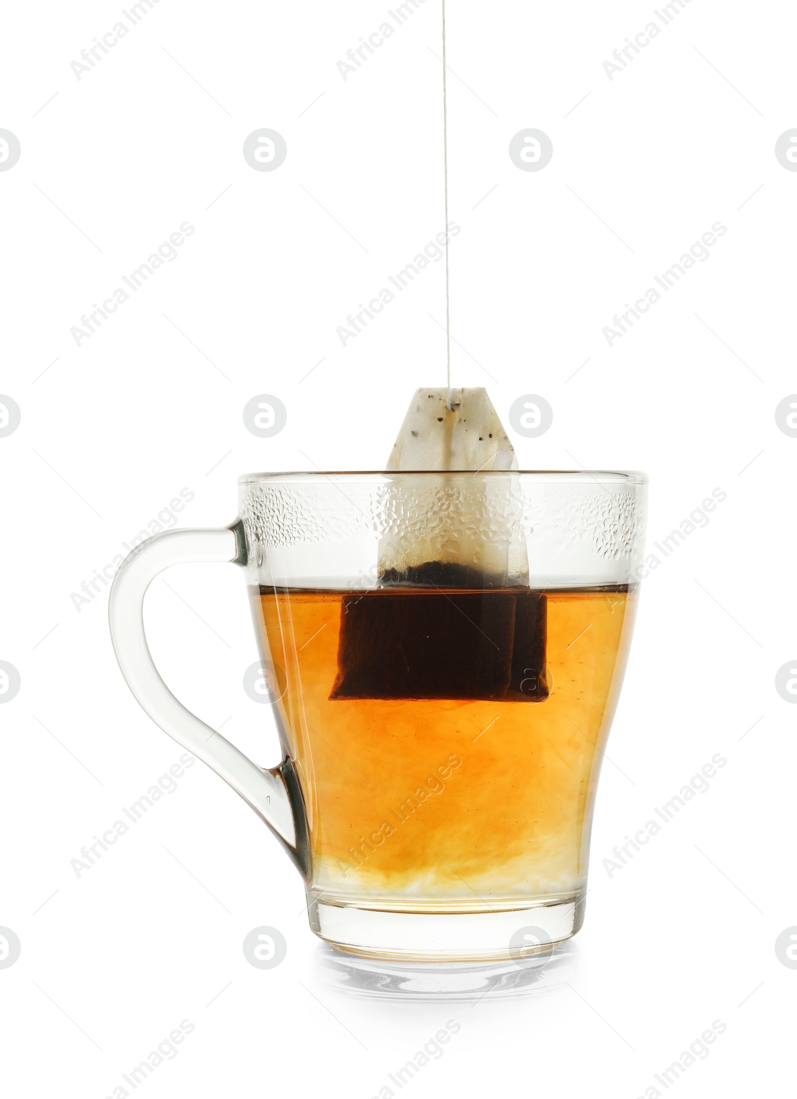 Photo of Cup with teabag isolated on white. Brewing aromatic tea