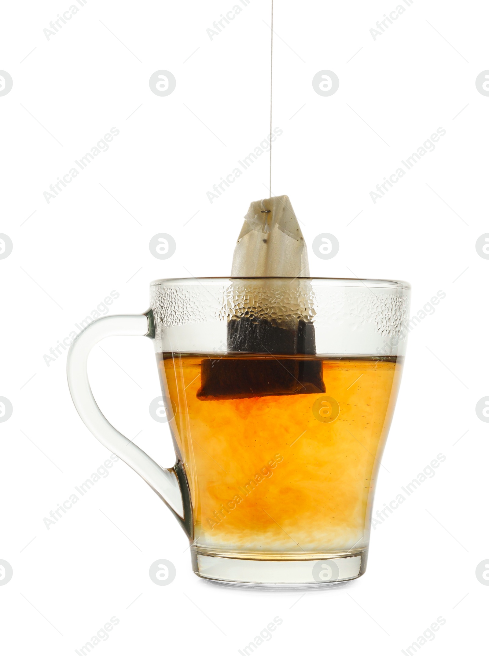 Photo of Brewing aromatic tea. Cup with teabag isolated on white