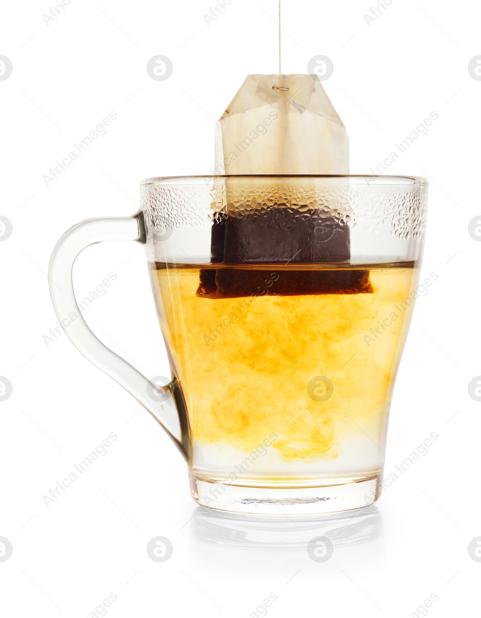 Photo of Brewing aromatic tea. Cup with teabag isolated on white