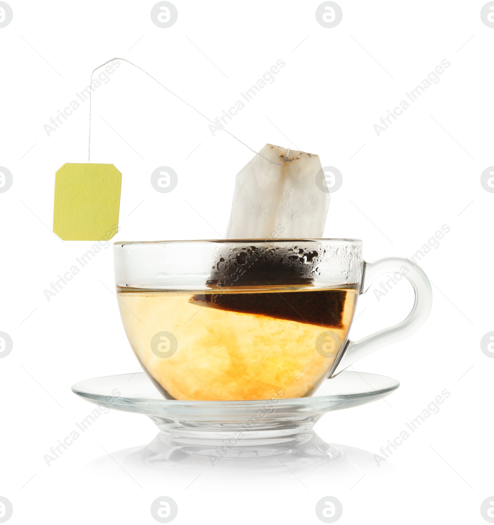 Photo of Brewing aromatic tea. Cup with teabag isolated on white