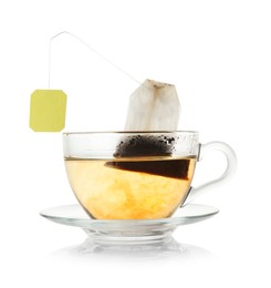 Photo of Brewing aromatic tea. Cup with teabag isolated on white