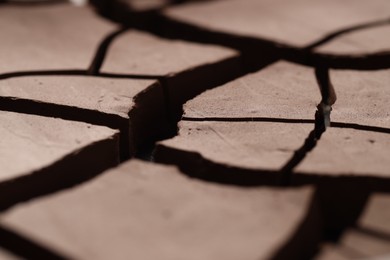 Photo of Dry cracked ground as background, closeup. Global warming