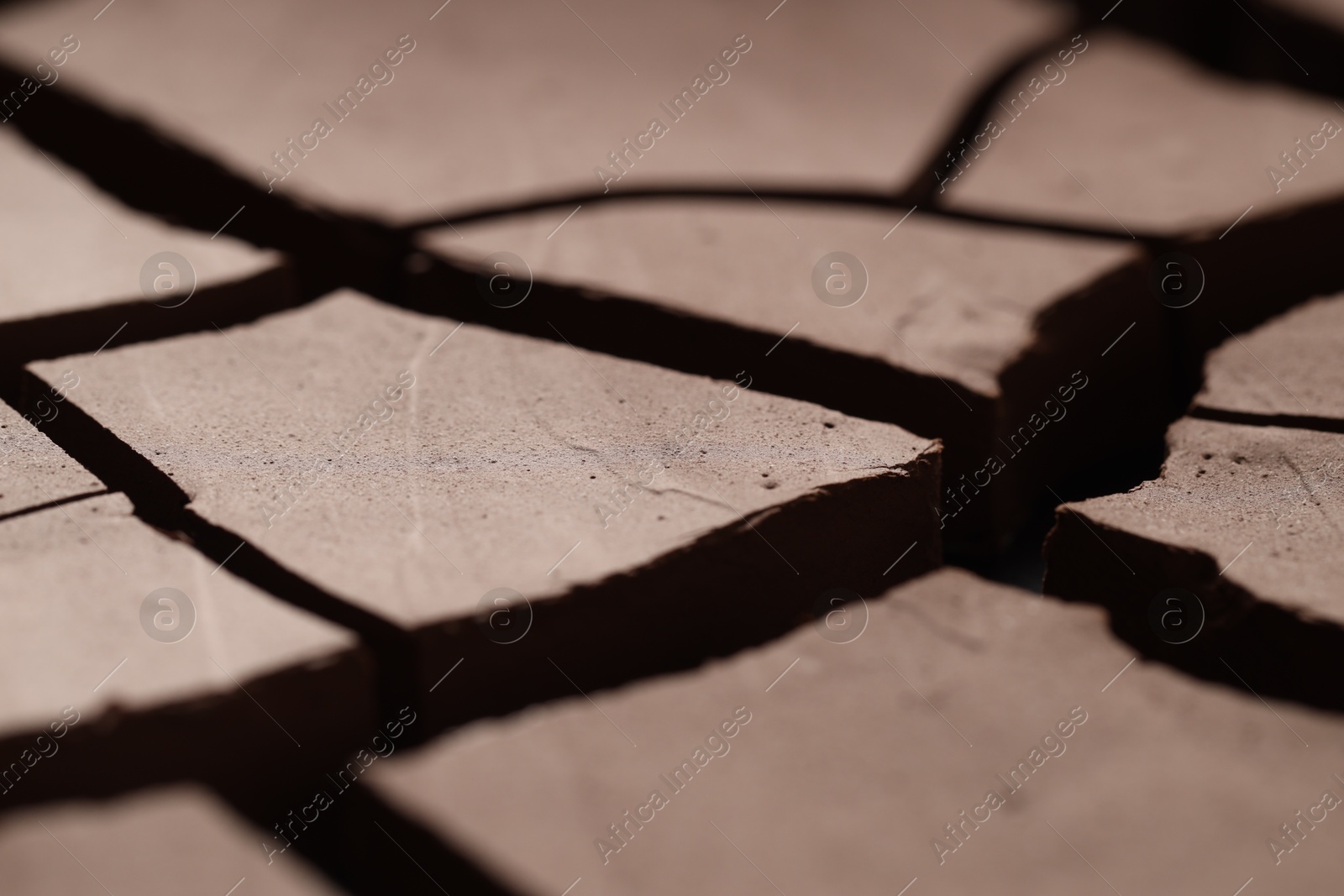 Photo of Dry cracked ground as background, closeup. Global warming