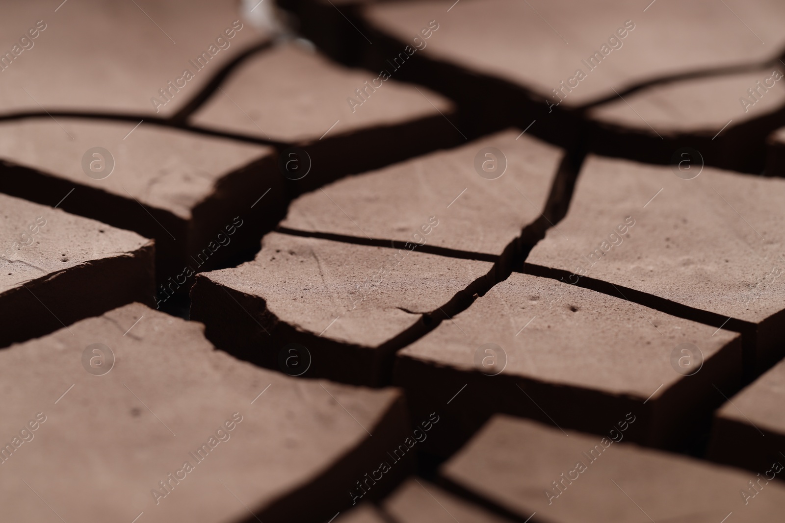 Photo of Dry cracked ground as background, closeup. Global warming