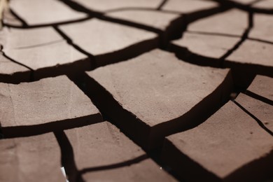 Photo of Dry cracked ground as background, closeup. Global warming