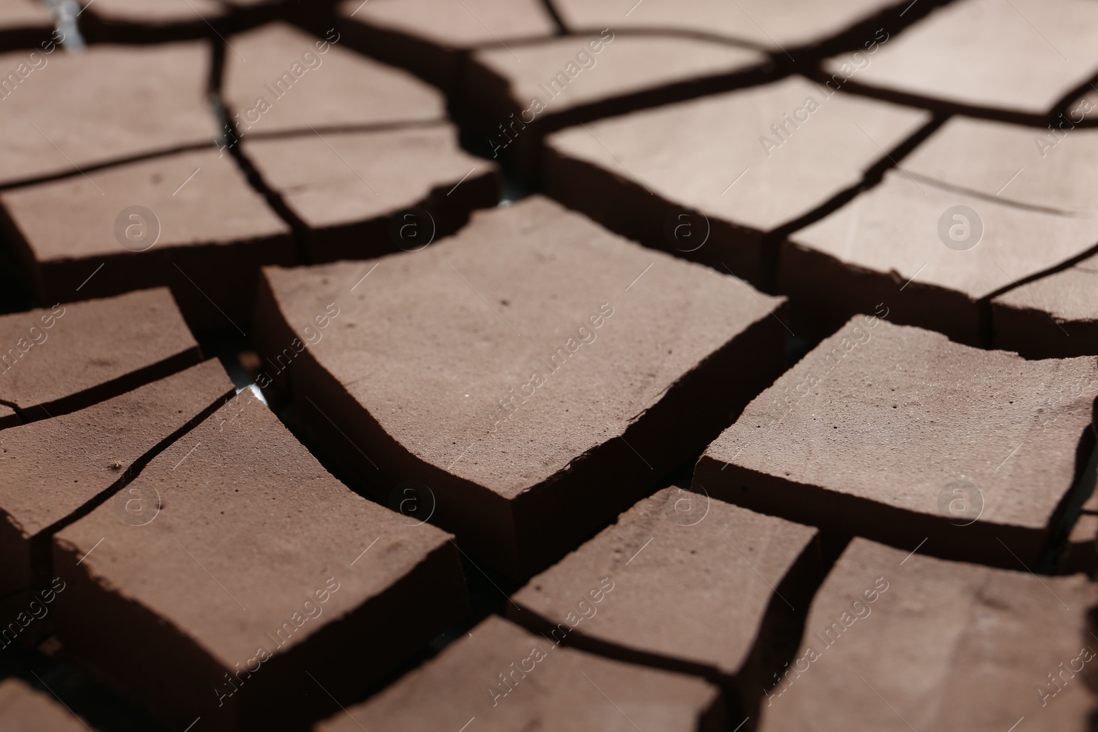 Photo of Dry cracked ground as background, closeup. Global warming