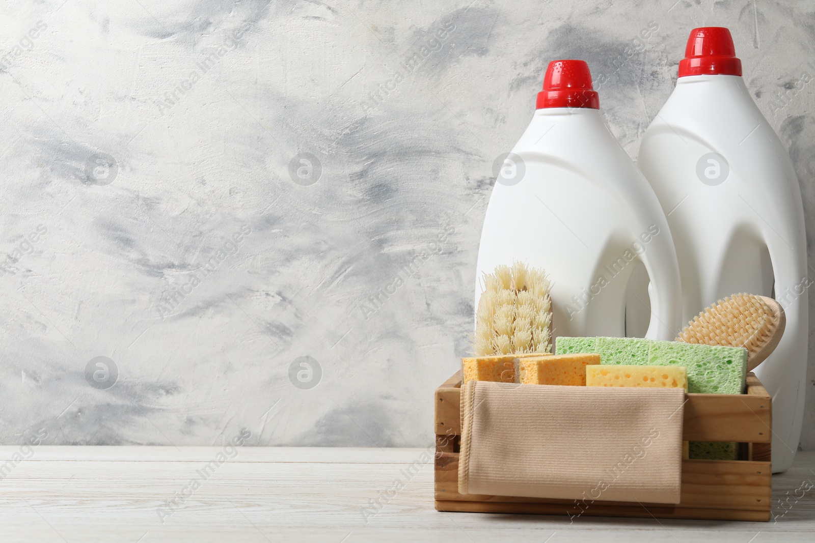 Photo of Eco-friendly cleaning products and supplies on light wooden table, space for text