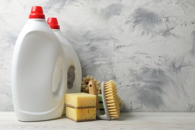 Photo of Eco-friendly cleaning products and supplies on light wooden table, space for text