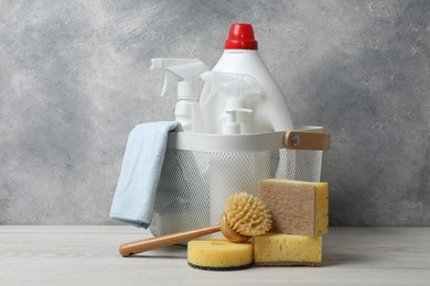 Photo of Eco-friendly cleaning products and supplies on light wooden table