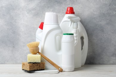 Photo of Eco-friendly cleaning products and supplies on light wooden table