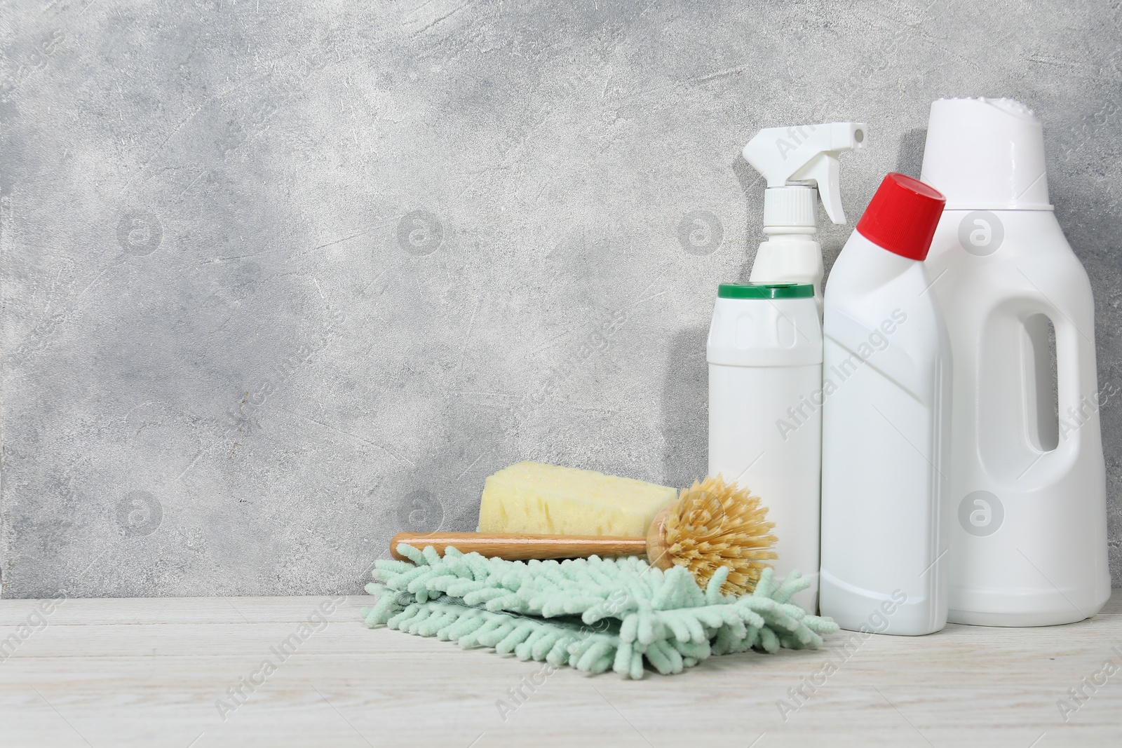 Photo of Eco-friendly cleaning products and supplies on light wooden table, space for text