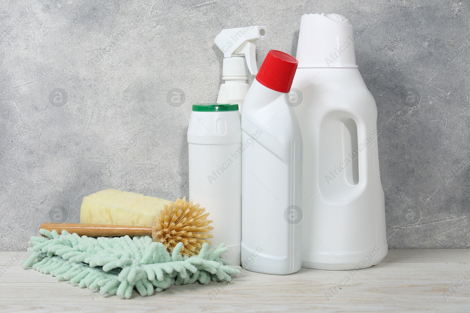 Photo of Eco-friendly cleaning products and supplies on light wooden table