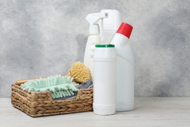 Photo of Eco-friendly cleaning products and supplies on light wooden table