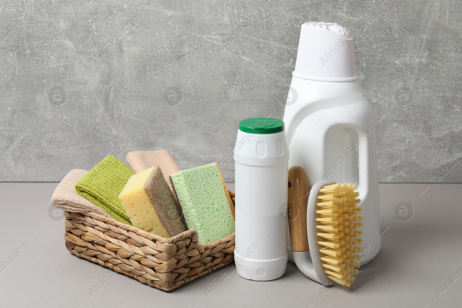 Photo of Eco-friendly cleaning products and supplies on grey table