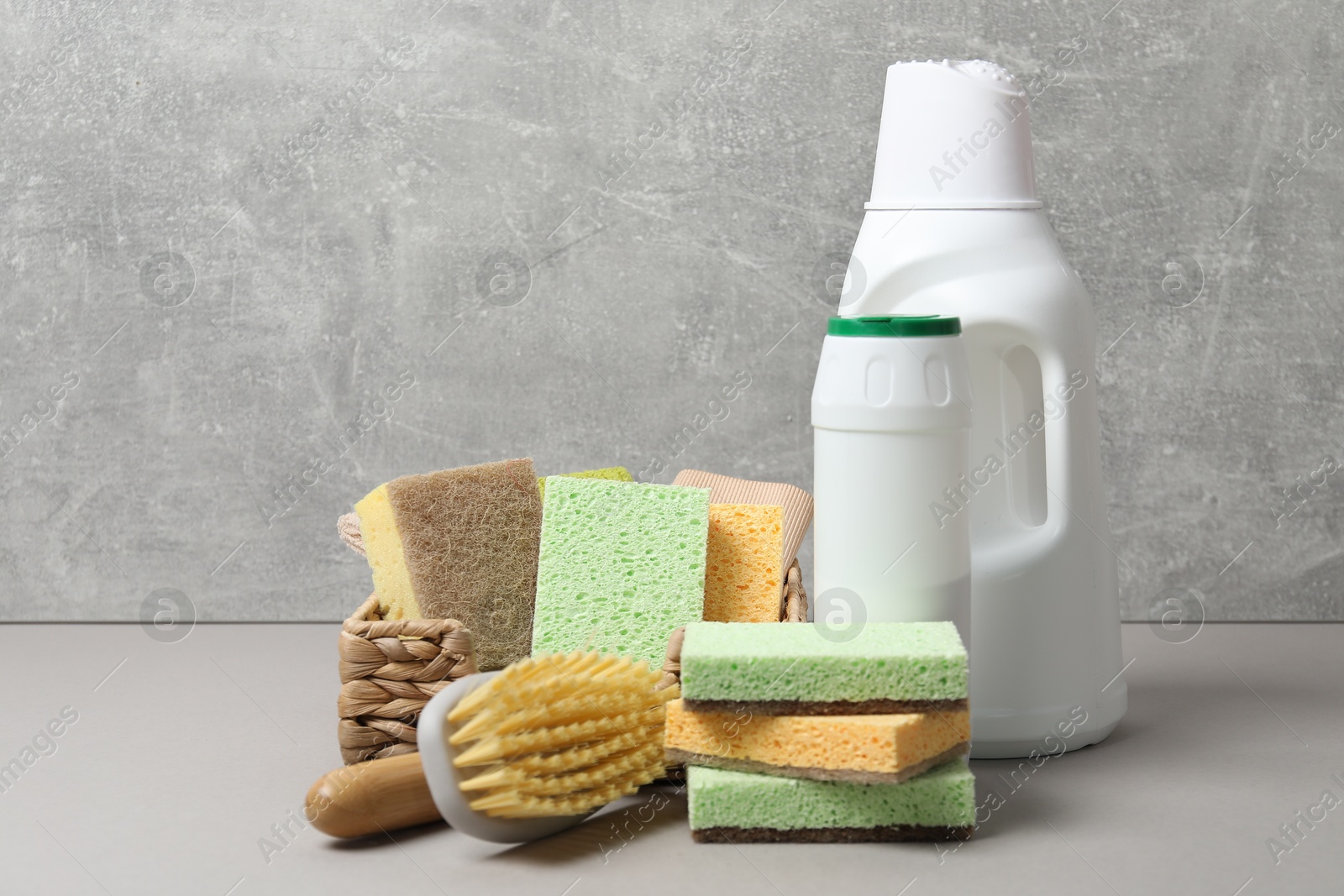 Photo of Eco-friendly cleaning products and supplies on grey table