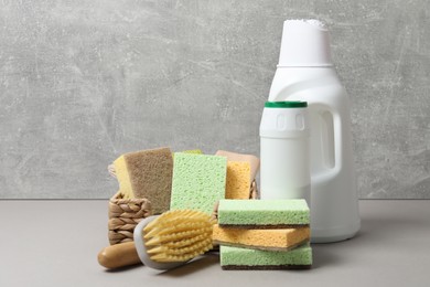 Photo of Eco-friendly cleaning products and supplies on grey table