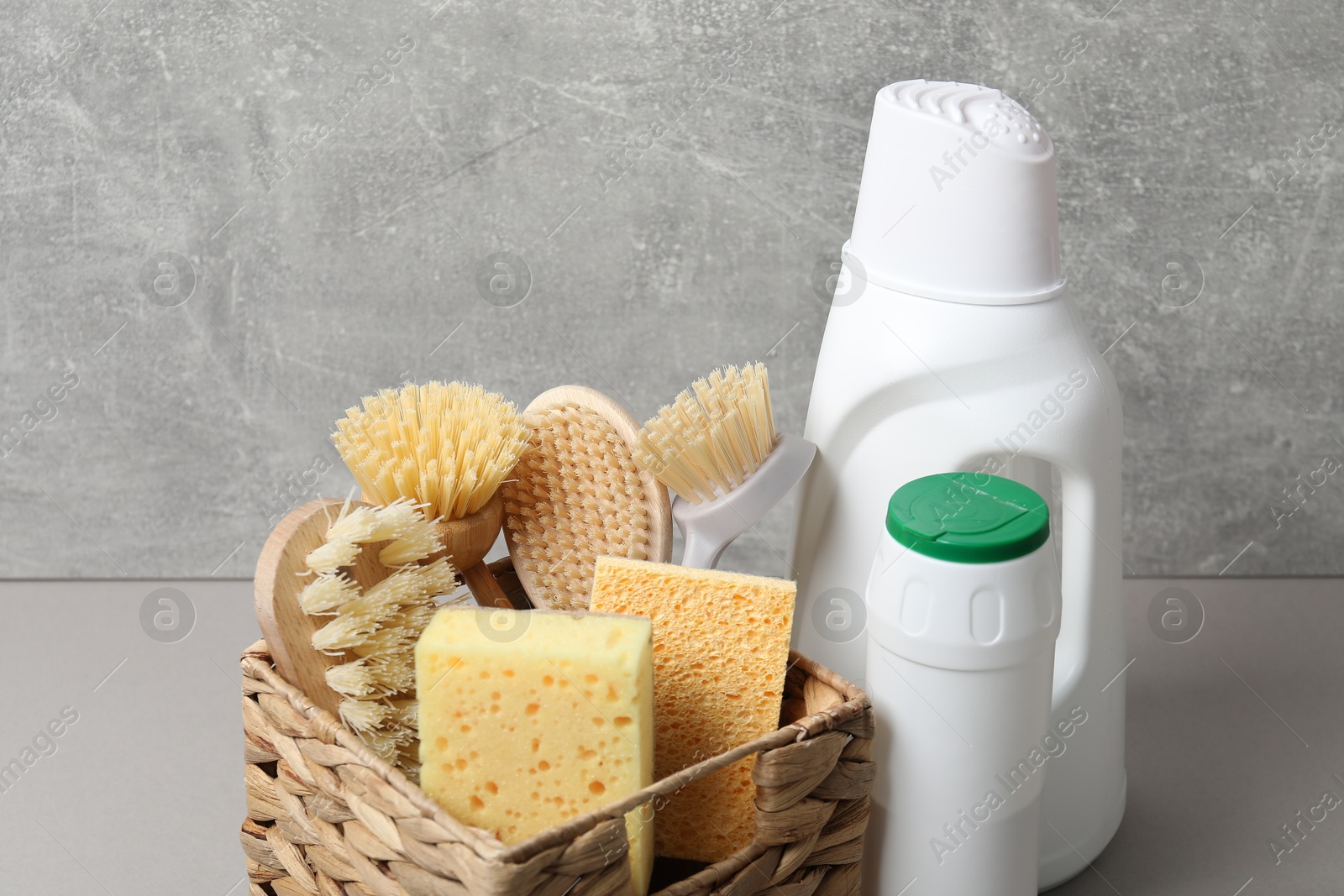 Photo of Eco-friendly cleaning products and supplies on grey table, closeup