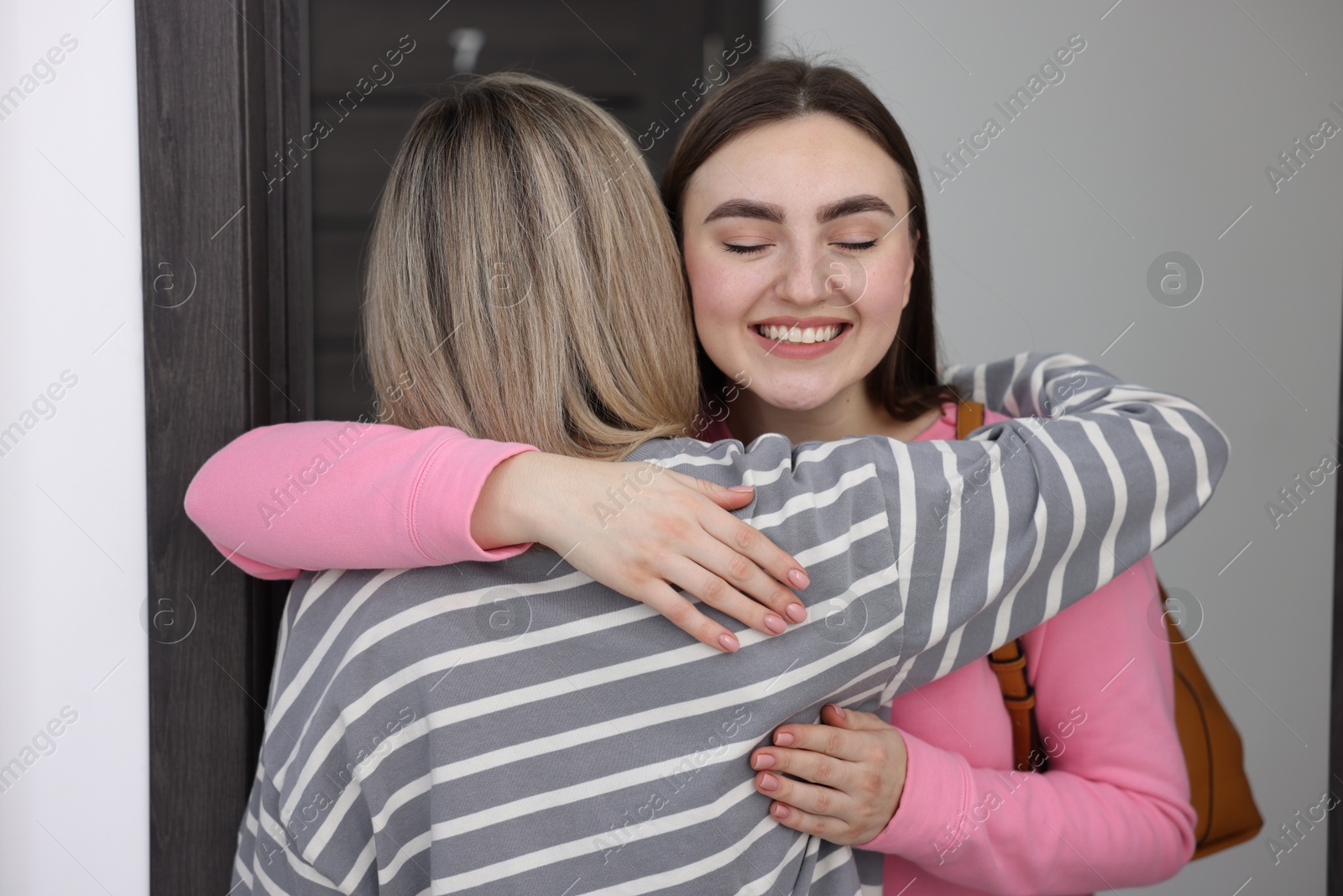 Photo of Woman welcoming friend to her new apartment