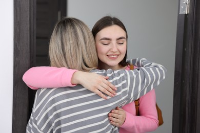 Woman welcoming friend to her new apartment