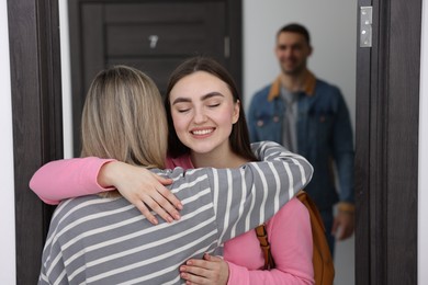 Woman welcoming friends to her new apartment