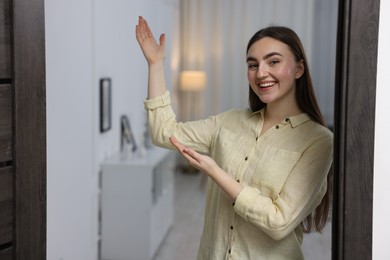 Happy woman welcoming guests to her house