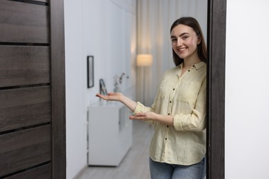 Happy woman welcoming guests to her house