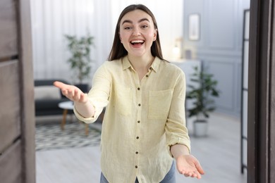 Happy woman welcoming guests to her house