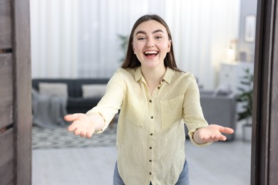 Happy woman welcoming guests to her house