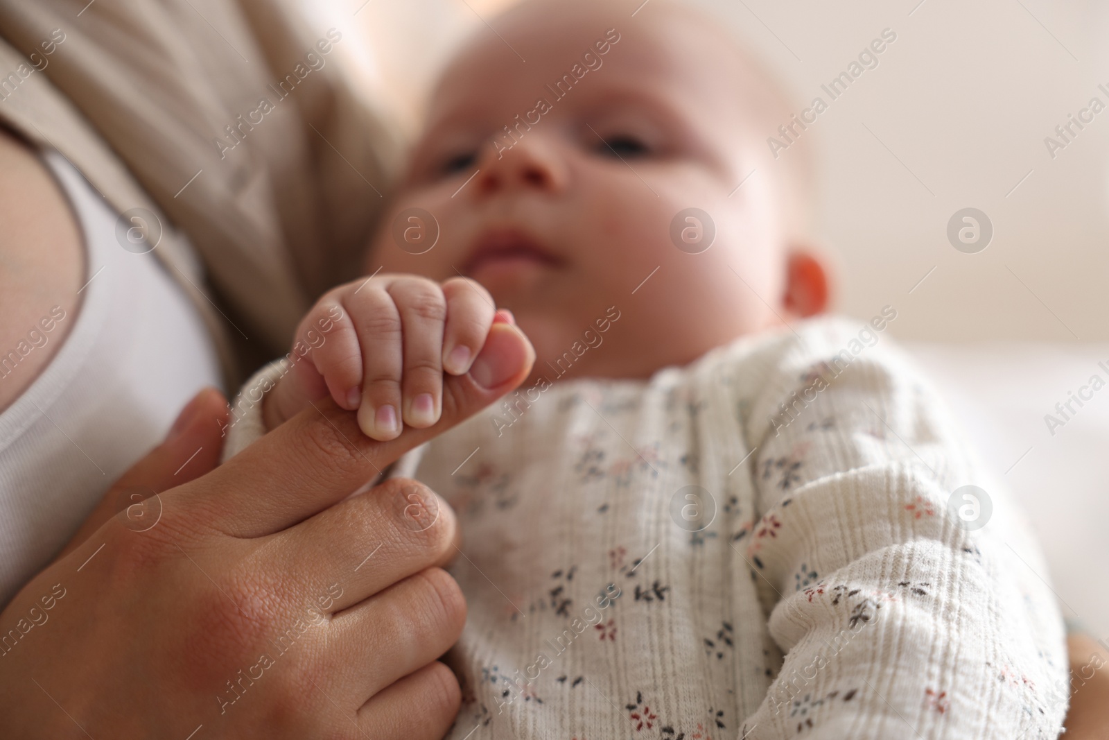 Photo of Mother with her cute little baby at home, closeup