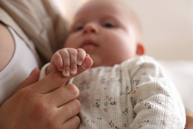 Mother with her cute little baby at home, closeup