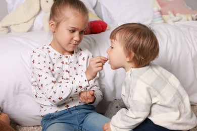 Photo of Sister and brother spending time together at home