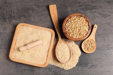 Photo of Oat bran and grains on grey table, flat lay