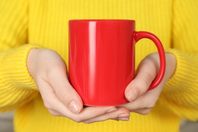 Photo of Woman with red ceramic cup, closeup. Mockup for design