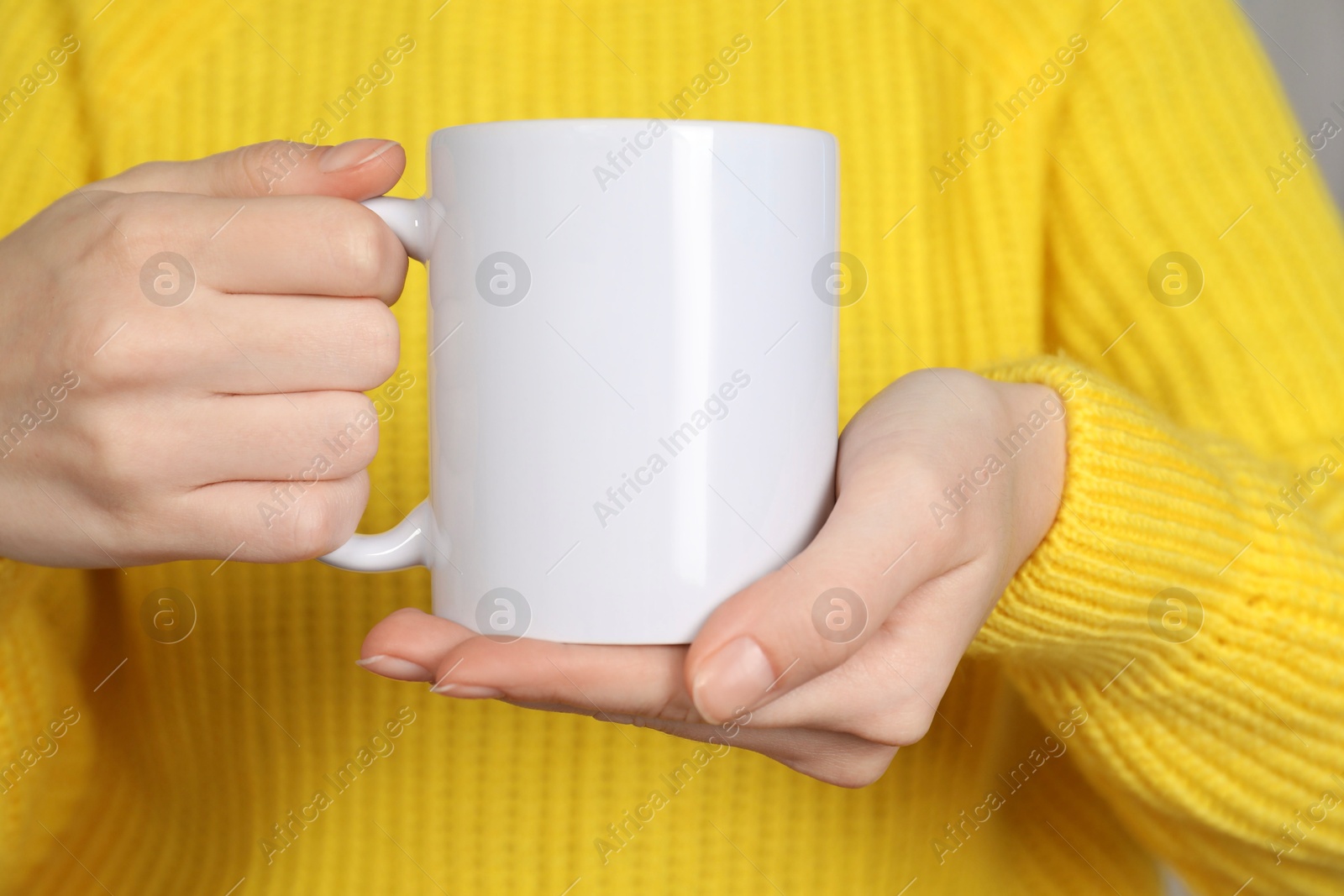 Photo of Woman with white ceramic cup, closeup. Mockup for design