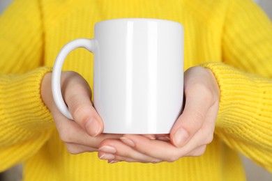 Photo of Woman with white ceramic cup, closeup. Mockup for design