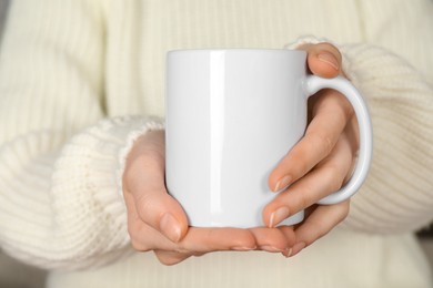 Photo of Woman with white ceramic cup, closeup. Mockup for design