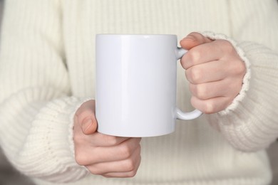 Photo of Woman with white ceramic cup, closeup. Mockup for design