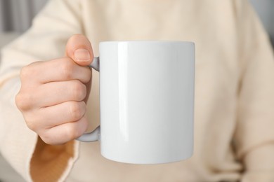 Photo of Woman with white ceramic cup, closeup. Mockup for design