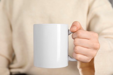 Photo of Woman with white ceramic cup, closeup. Mockup for design