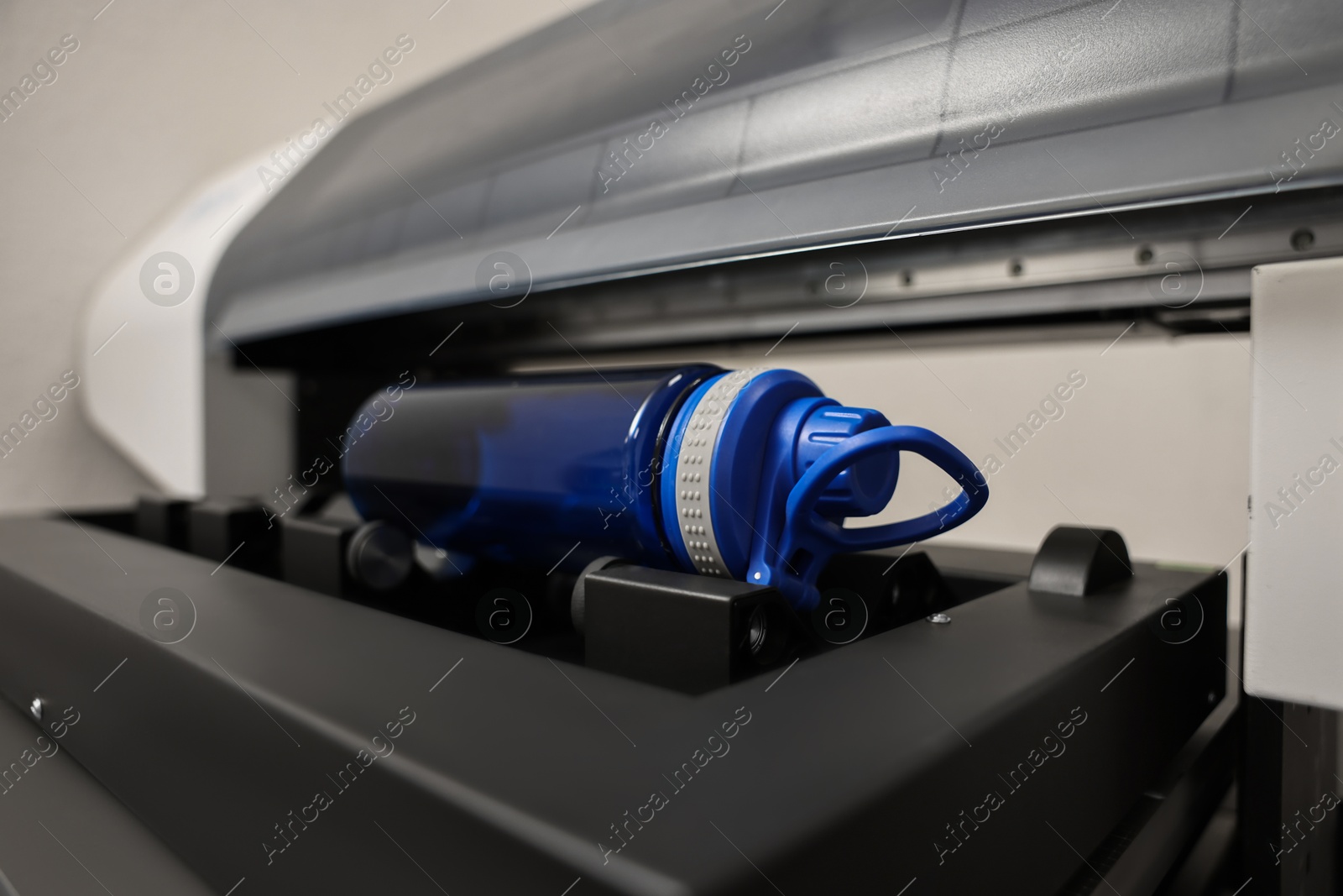 Photo of Modern printer and empty bottle indoors, closeup