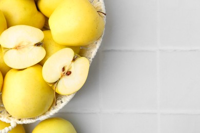 Photo of Fresh ripe yellow apples on white tiled table, flat lay. Space for text